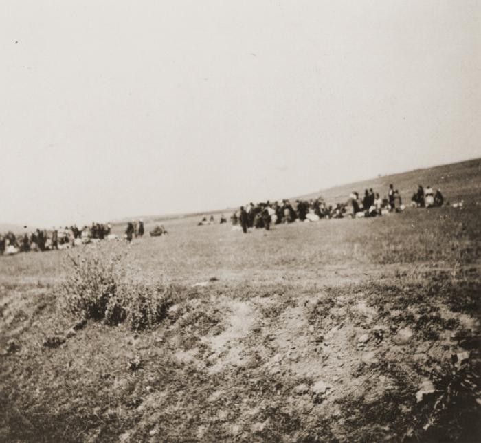 Most Jews deported from Hungary were executed by the SS along with local Jews in Kamenets-Podolsk, Ukraine. 23,600 people were murdered in three days. The image shows Hungarian and Ukrainian Jews waiting before execution on the edge of town. (Photo: United States Holocaust Memorial Museum)